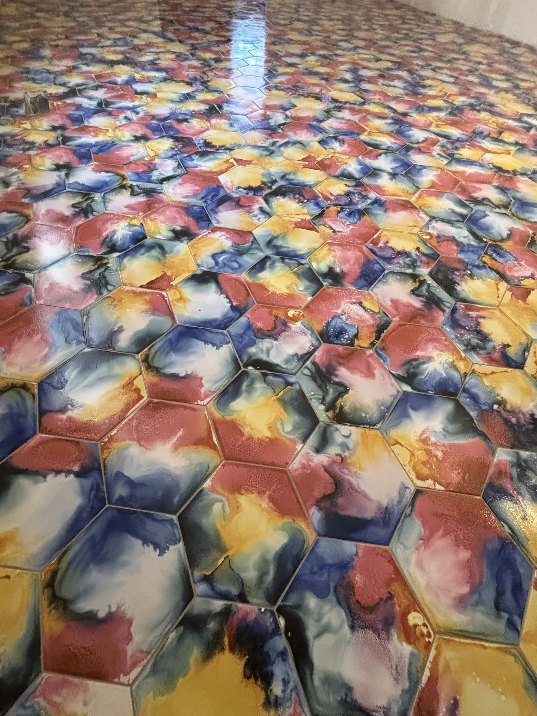 Watercolor hexagon floor tile in red, blue, and yellow