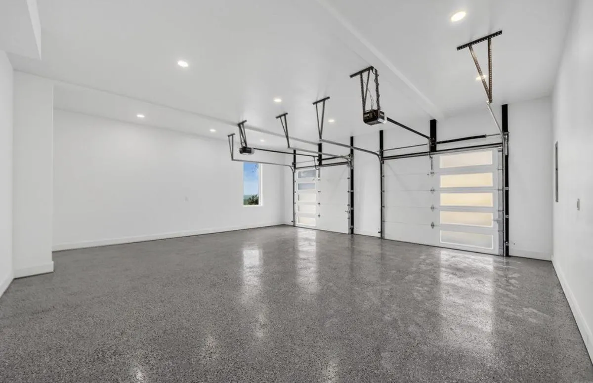 Finished garage with a polished floor and glass garage doors